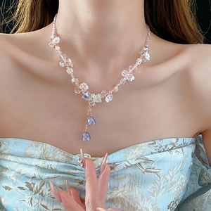 Detail of flower crystal tassel necklace with pink beads and blue teardrop pendants