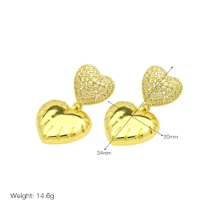 Detail showing heart-shaped gold drop earrings with 34mm height and 14.6g weight specs
