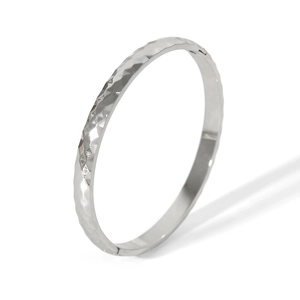Detailed view of silver stainless steel bangle with a unique hammered textured finish