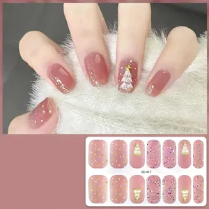 Close-up of Christmas gel nail stickers CS-417 featuring golden trees and pink glitter details