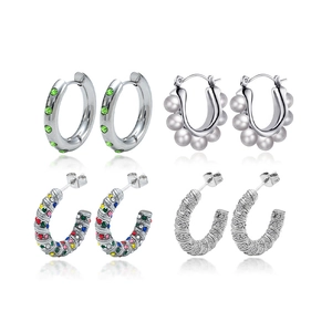 Set of four vintage silver stainless steel earrings with zircons and pearls on white background