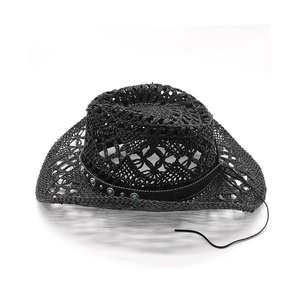 Detail of hollow woven straw cowboy hat with turquoise and silver vintage embellishments