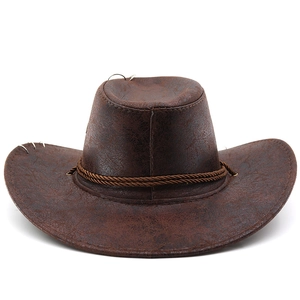 Detail of vintage brown cowboy hat with leather texture, metal rings and braided rope