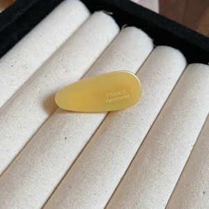 Détail d'une pince à cheveux goutte jaune faite à la main avec gravure France Handmade