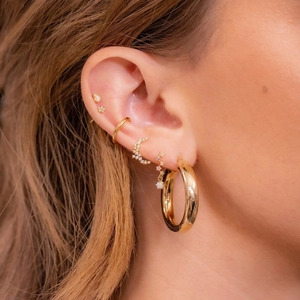 Set of 18K gold plated zircon earrings featuring hoops and moon studs on a model