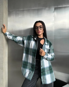 Close-up of green and white plaid wool flannel shirt with button-up front and collar