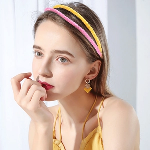 Women's sparkling sequin headbands in pink and yellow with elegant geometric earrings
