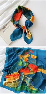 Detailed close-up of blue ginkgo leaf print silk scarf with knotted and flat textures