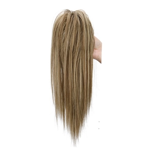 Hand holding a long straight blonde mixed ponytail hair extension with claw clip