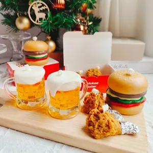 Detailed view of burger and beer shaped scented candles for creative party decor