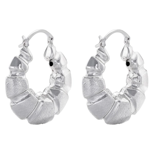 Macro detail of silver hollow C-shape hoop earrings with textured bamboo surface pattern