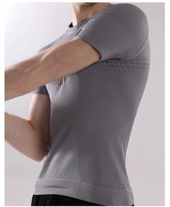 Detail of grey compression workout tee showing seamless texture and breathable mesh side panels
