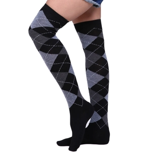 Detail of high elastic over-the-knee socks with classic black and grey diamond pattern