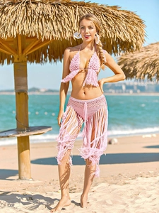 Close-up of pink crochet bikini set with hollow out lace and long tassel hem details