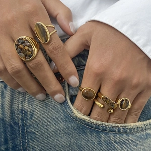 Bohemian gold stainless steel rings set with natural tiger eye stones on model hand