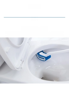 Detail of emery-infused curved toilet brush head cleaning rim and corners effectively