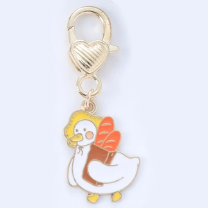 Detail of cute duck keychain with baguette backpack and heart lobster clasp