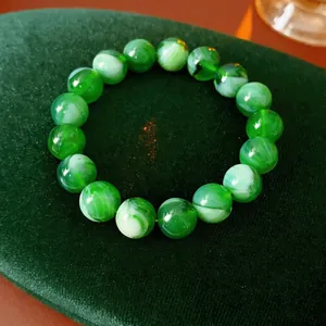 Elegant green beaded bracelet with cloud texture on luxury velvet display stand