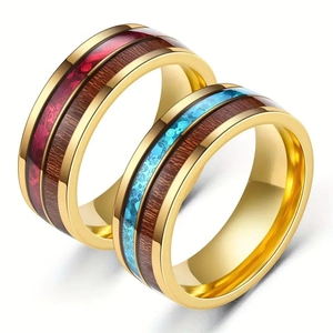 Detailed macro of 8mm gold stainless steel rings with wood inlay and crushed resin texture