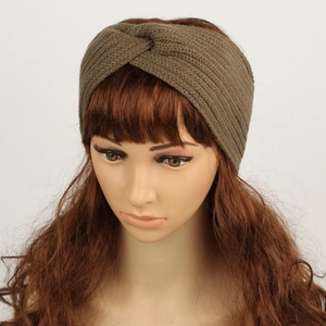 Close-up of winter knit headband with twisted knot design in dark coffee brown