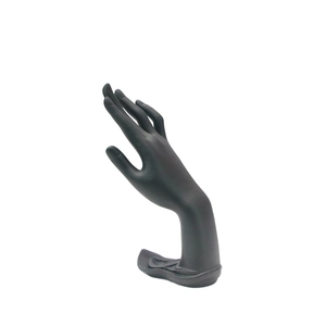 Black matte hand-shaped jewelry display stand for rings and bracelets on white background
