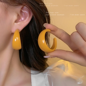 Ginger yellow acrylic C-shaped hoop earrings with a glossy finish for a retro style