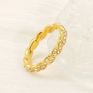 Detailed view of gold twisted rope ring featuring sparkling white pavé cubic zirconia