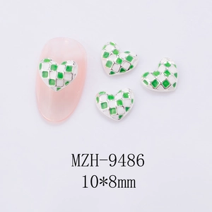 Macro shot of 10x8mm green checkered heart nail charms with silver alloy plating