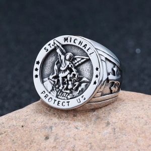 Vintage St. Michael stainless steel seal ring with cross detail on natural stone base
