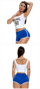 Detail of two-piece sports set with white crop top and blue piped athletic shorts