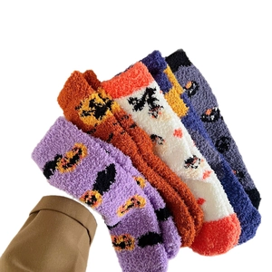 Set of five plush coral fleece Halloween socks featuring pumpkin patterns in vibrant colors