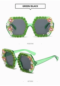 Close-up of green square sunglasses with floral crystals and pink gemstones details