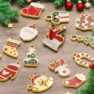 Enamel Christmas charms set including Santa and reindeer on wooden background