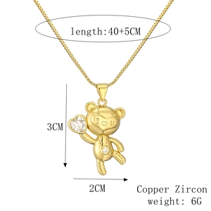 Detail of gold bear necklace with size specs, zirconia heart, and I love U engraving