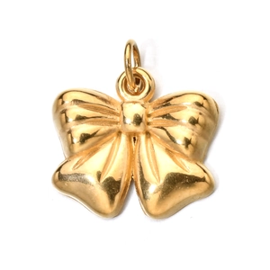 Macro shot of gold stainless steel bow pendant with a polished metallic finish
