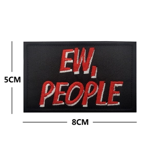 Close-up of EW PEOPLE embroidered patch showing 8cm x 5cm dimensions on white background