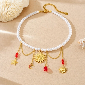 Chic multi-layer pearl necklace with sun star moon charms on beach sand background