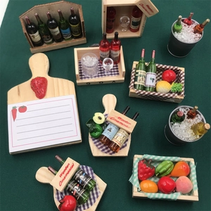 Miniature wooden wine rack and fruit basket ornaments on dark green background