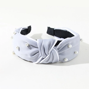 Detail of light blue knotted satin headband with white faux pearls and anti-slip lining