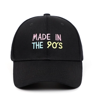 Black cotton baseball cap featuring colorful MADE IN THE 90'S embroidery on a white background