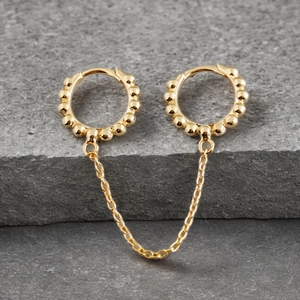 Detail of gold S925 silver double hoop earrings connected by a delicate chain link