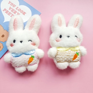 Cute plush white bunny pins with carrot embroidery and colorful collars on pink background