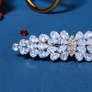 Macro shot of silver hair clip featuring sparkling pear and marquise-cut zircon leaf patterns