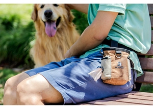 Outdoor pet training treat pouch worn by owner with golden retriever in park setting