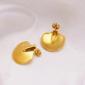 Elegant 18K gold plated geometric petal earrings on white satin fabric background