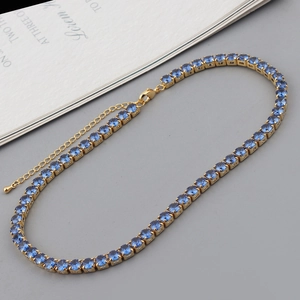 Detail of colorful zircon tennis necklace featuring gold-plated chain and lobster clasp