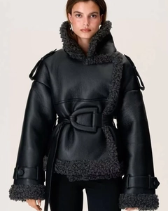 Detail of faux shearling collar and leather waist belt on women's biker jacket