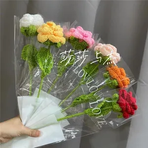 Detail of colorful handmade crochet flowers with elegant clear plastic gift packaging