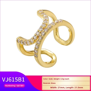 Detailed close-up of a gold brass X-shaped ear cuff featuring white zircon stone inlay