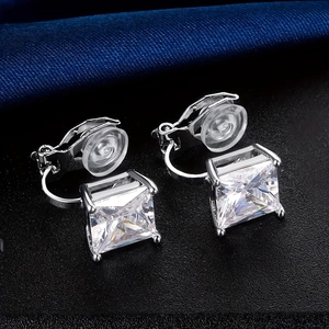 Elegant silver square-cut zircon ear clips on a luxurious black and blue background